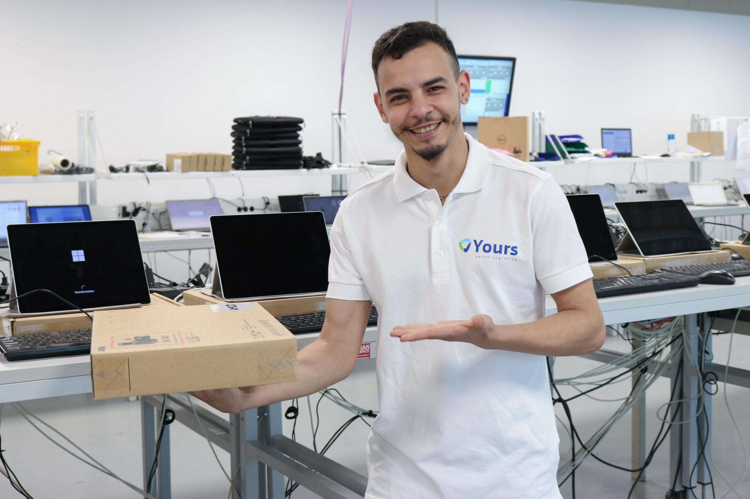 Medewerker van Yours staat trots met pakketje in zijn handen